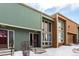 Exterior angle shot showcasing a sage and tan townhouse with large windows and snowy landscaping at 4950 Homestead Pl # 23, Thornton, CO 80229