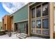 Townhouse exterior with neutral trim, sage siding, and multiple windows reflecting cloudy skies at 4950 Homestead Pl # 23, Thornton, CO 80229