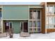 Townhouse exterior exhibiting sage siding, neutral trim, and multiple windows, enhanced by winter's snow at 4950 Homestead Pl # 23, Thornton, CO 80229