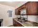 Kitchen featuring stainless steel sink and granite countertops at 4950 Homestead Pl # 23, Thornton, CO 80229