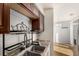Stainless steel dual sink featuring updated faucet fixtures, dish rack, and granite countertops at 4950 Homestead Pl # 23, Thornton, CO 80229