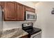 Updated kitchen featuring stainless steel microwave and black stove at 4950 Homestead Pl # 23, Thornton, CO 80229