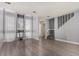 Bright living room features large windows with sheer curtains and gray wood-look flooring at 4950 Homestead Pl # 23, Thornton, CO 80229