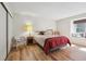 Comfortable bedroom features a window seat, hardwood floors, and ample natural light at 23561 Genesee Village Road # C, Golden, CO 80401