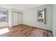 Empty bedroom with wood-look floors, white trim and neutral walls at 23561 Genesee Village Road # C, Golden, CO 80401
