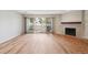 Inviting living room with a cozy fireplace, balcony access, and beautiful wood laminate flooring at 23561 Genesee Village Road # C, Golden, CO 80401