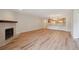 Spacious living room with fireplace and adjacent kitchen with wooden cabinets and stainless steel appliances at 23561 Genesee Village Road # C, Golden, CO 80401