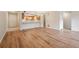 Spacious living area with wood laminate floors, adjacent to a modern kitchen, with an open concept design at 23561 Genesee Village Road # C, Golden, CO 80401