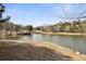 Picturesque community pond view with dock, mature trees, and beautiful natural scenery at 23561 Genesee Village Road # C, Golden, CO 80401