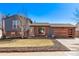 Charming two-story home with a brick and blue wood exterior and a beautifully landscaped front yard at 19228 E Arizona Pl, Aurora, CO 80017