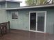 The exterior shows a wooden deck with an open glass door into the house; good natural light and an outdoor retreat at 880 Orion Dr, Lafayette, CO 80026