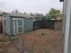 A fully fenced backyard features gravel ground cover, garden shed, and an enclosed pet area ready for outdoor living at 880 Orion Dr, Lafayette, CO 80026