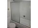 Bathroom featuring a tub with sliding glass doors and white tile at 880 Orion Dr, Lafayette, CO 80026
