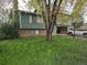 Two-story home with brick accents, attached garage, tree in the front yard at 880 Orion Dr, Lafayette, CO 80026