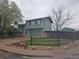 Two-story home with attached garage, basketball hoop, and fenced yard at 880 Orion Dr, Lafayette, CO 80026