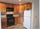 Kitchen featuring wooden cabinets, black appliances, and tile backsplash at 880 Orion Dr, Lafayette, CO 80026