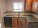 Kitchen with stainless steel sink and built-in shelves, and backsplash at 880 Orion Dr, Lafayette, CO 80026