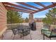 Outdoor deck with pergola, featuring a dining table, seating, and a grill at 9784 S Iris Ct, Littleton, CO 80127
