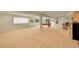 Expansive basement area with a pool table, wet bar, and large windows providing natural light at 9784 S Iris Ct, Littleton, CO 80127