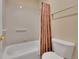 Bathroom with white tiled shower and a white toilet at 9784 S Iris Ct, Littleton, CO 80127