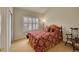 Bedroom with carpeted floor, a window with shutters, and a comfy bed at 9784 S Iris Ct, Littleton, CO 80127