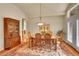 Formal dining room featuring a wood table, chandelier, and hardwood floors at 9784 S Iris Ct, Littleton, CO 80127