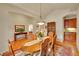 Formal dining room with wood table, chairs, hardwood floors, area rug, and wood hutch at 9784 S Iris Ct, Littleton, CO 80127