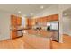 Kitchen featuring wood cabinets, granite countertops, stainless steel appliances, and island at 9784 S Iris Ct, Littleton, CO 80127