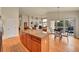 Open floor plan showcases kitchen island, living room, and dining area with hardwood floors at 9784 S Iris Ct, Littleton, CO 80127