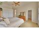 Main bedroom with ensuite bathroom, ceiling fan, carpet and large closet at 9784 S Iris Ct, Littleton, CO 80127