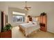 Main bedroom with ensuite bathroom, vaulted ceiling, ceiling fan and a large bright window at 9784 S Iris Ct, Littleton, CO 80127