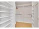 Walk-in closet with built-in shelving and hanging rods for clothing storage at 9784 S Iris Ct, Littleton, CO 80127