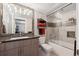 Modern bathroom with a tub, tiled shower, sleek vanity, and stylish mirror at 2898 W 22Nd Ave, Denver, CO 80211