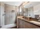 Modern bathroom featuring tiled shower with shelves, dual sinks, and sleek vanity at 2898 W 22Nd Ave, Denver, CO 80211