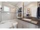 Modern bathroom featuring a tub, tiled shower, sleek vanity, and stylish mirror at 2898 W 22Nd Ave, Denver, CO 80211