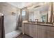 Modern bathroom featuring tiled shower with bench, dual sinks, and sleek vanity at 2898 W 22Nd Ave, Denver, CO 80211