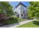 Modern home featuring well-maintained lawn, mature trees, and a contemporary design at 2898 W 22Nd Ave, Denver, CO 80211