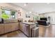 Open kitchen featuring stainless steel appliances and an island, flowing into the living area at 2898 W 22Nd Ave, Denver, CO 80211