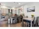 A modern kitchen features sleek cabinetry, stainless steel appliances, and an island with seating at 2898 W 22Nd Ave, Denver, CO 80211