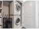 A functional laundry room with a stacked washer and dryer, maximizing space at 2898 W 22Nd Ave, Denver, CO 80211