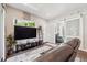 Cozy living room with a sleek entertainment center, modern decor, and sliding door access at 2898 W 22Nd Ave, Denver, CO 80211