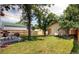 Spacious backyard with mature trees, new fence, and a seating area for outdoor dining at 4344 Chase St, Denver, CO 80212