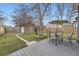 Private backyard featuring a wooden deck with umbrella-covered table and chairs, and storage shed at 4344 Chase St, Denver, CO 80212