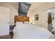 Comfortable bedroom with a wooden headboard, soft lighting, and easy access to an ensuite bathroom at 4344 Chase St, Denver, CO 80212