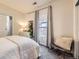 Cozy bedroom with a soft, inviting bed, large window and calming decor, perfect for relaxation at 4344 Chase St, Denver, CO 80212