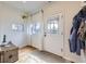 Inviting entryway with natural light, hardwood floors, and charming white door at 4344 Chase St, Denver, CO 80212