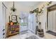 Bright entryway featuring white cabinets, tile flooring, and glass sliding door to the backyard at 4344 Chase St, Denver, CO 80212
