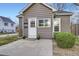 Charming home with gray siding, a white door, and neatly trimmed landscaping adding to its curb appeal at 4344 Chase St, Denver, CO 80212