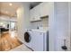 Functional laundry room with modern appliances, built-in storage, and easy access to other living spaces at 4344 Chase St, Denver, CO 80212