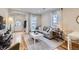 Inviting living room featuring a comfortable gray sofa, hardwood floors, and ample natural light from the windows at 4344 Chase St, Denver, CO 80212